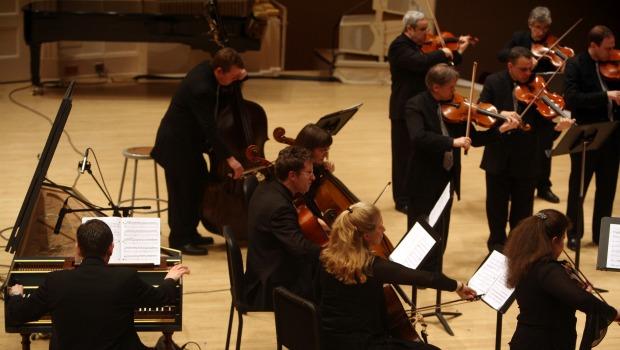 String players of Orpheus stand while playing Christopher Theofanidis's 'Muse' during the Orpheus concert Friday night. String players of Orpheus stand while playing Christopher Theofanidis's 'Muse' during the Orpheus concert Friday night.