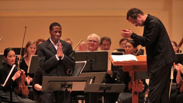 Conductor David Allan Miller bows to baritone soloist Nathan De’Shon Myers. Conductor David Allan Miller bows to baritone soloist Nathan De’Shon Myers.