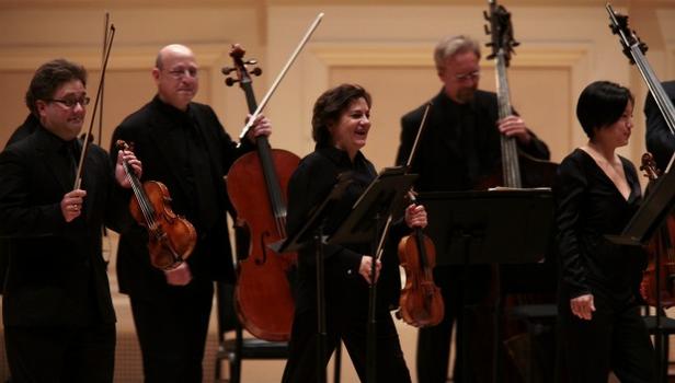 The violinists and violist of the St. Paul Chamber Orchestra stood to play Stravinsky's Concerto in D for strings The violinists and violist of the St. Paul Chamber Orchestra stood to play Stravinsky's Concerto in D for strings
