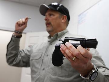 Gun instructor Mike Stilwell demonstrates a revolver as he teaches a packed class to obtain the Utah concealed gun carry permit, at Range Master of Utah, on January 9, 2016 in Springville, Utah.