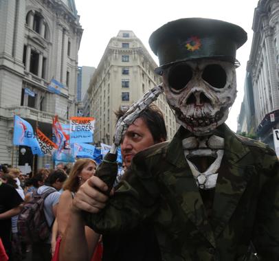 In Buenos Aires, a costumed demonstrator marks the anniversary of Argentina's 1976 military coup.
