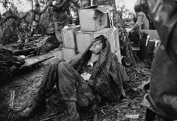 A U.S. paratrooper wounded in the battle for Hamburger Hill grimaces in pain as he awaits medical evacuation at base camp near the Laotian border, May 19, 1969.