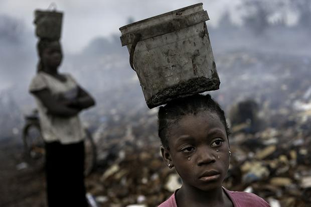 In an e-waste dump in that kills nearly everything that it touches, Fati, 8, works with other children searching through hazardous waste in hopes of finding whatever she can to exchange for pennies. dollar a day e-waste dump