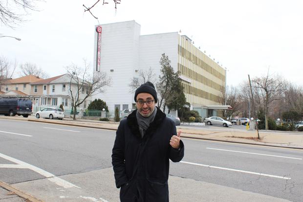 Writer Gary Shteyngart in front of the Kew Motor Inn, directly across from his family's first apartment in Queens.