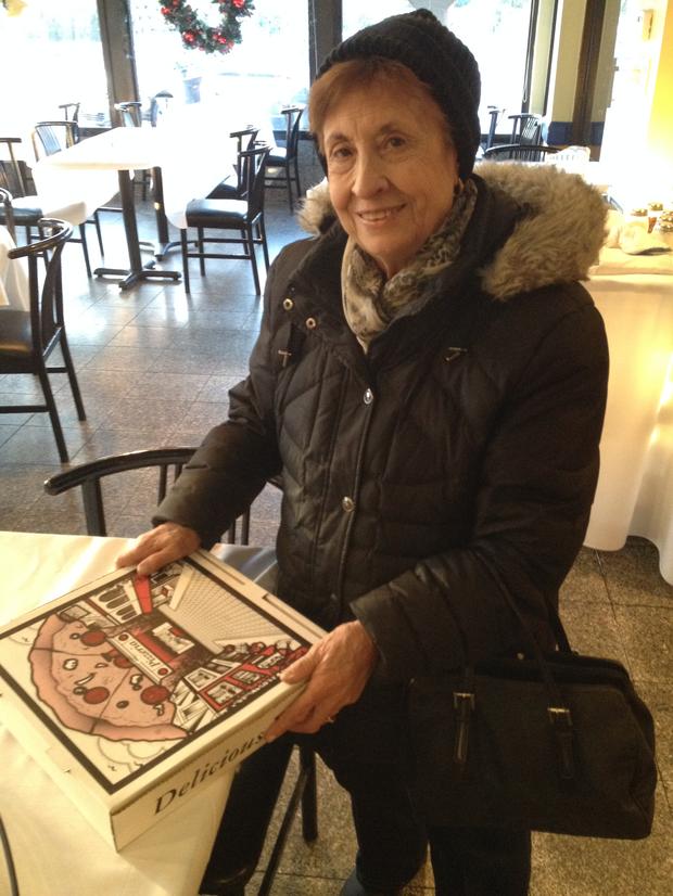 Angela Ricca, 83, picks up her pizza.