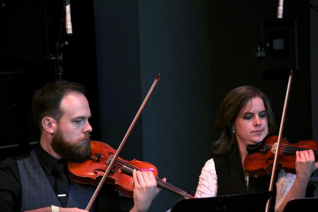 Violinists Joshua Modney and Olivia De Prato of the Mivos Quartet perform in the BAMcafé on the second day of the 2013 Crossing Brooklyn Ferry festival.