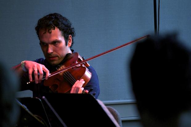 Violist Victor Lowrie of the Mivos Quartet performs in the BAMcafé on the second day of the 2013 Crossing Brooklyn Ferry festival.