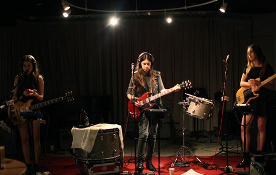 Alana Haim (left), Danielle Haim (center), and Este Haim (right) rehearse a cover of Fleetwood Mac’s “Oh Well.” Danielle prefers its “pre-Stevie, pre-Lindsey, bluesy vibes.”