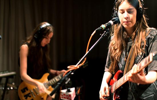 Youngest sister Alana Haim (left) on rhythm guitar and Danielle Haim (right).