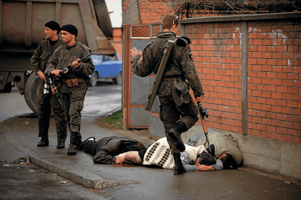 Arkan's Tigers, a Serbian paramilitary unit, with Bosnian Muslim civilian victims during the first battle for Bosnia in Bilijenia. 1992