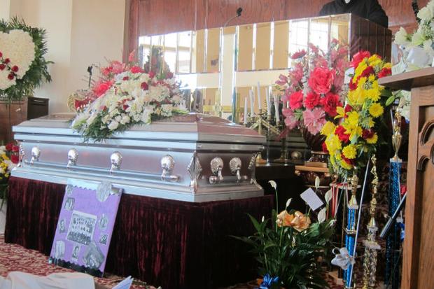 Ronald’s prized basketball trophies next to his casket. His team uniform and flag were buried with him, according to the family.