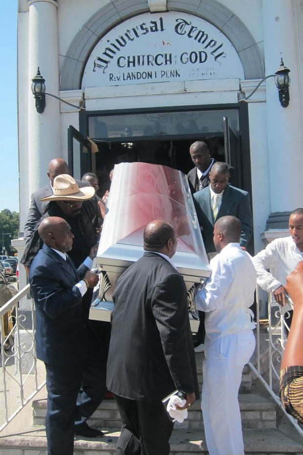 His silver casket being carried out of the church.