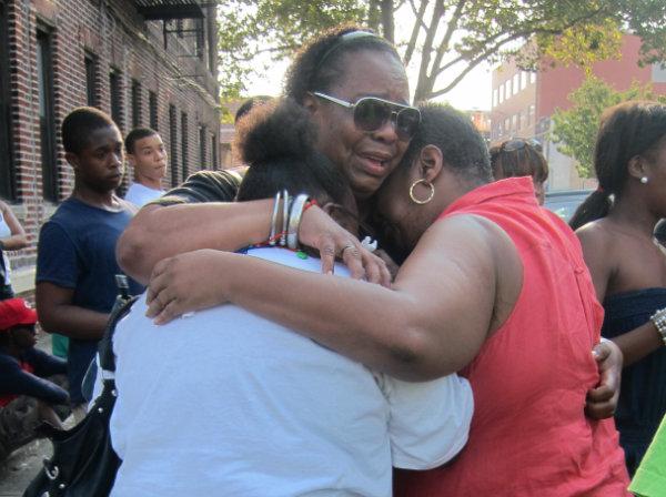 Relatives comforted each other at Ronald's vigil. ronald wallace, in harm's way