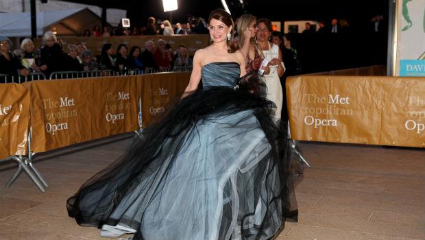 A patron arrives on the red carpet at the Metropolitan Opera's opening night