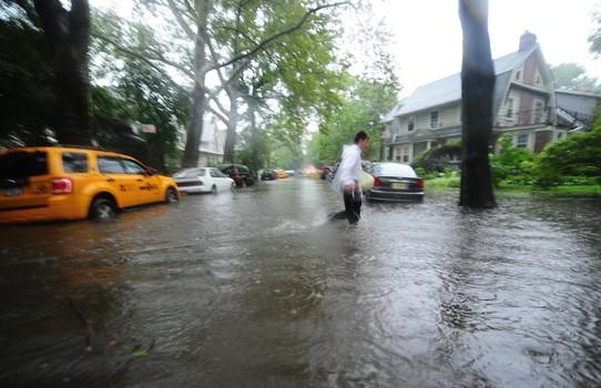 A man makes his way through a flooded street in Brooklyn, New York, August 28, 2011. A man makes his way through a flooded street in Brooklyn, New York, August 28, 2011.