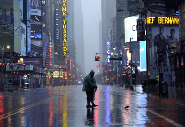 A man walks across 42nd Street in Times Square in New York on August 28, 2011 as Hurricane Irene hits the city and Tri State area with rain and high winds. A man walks across 42nd Street in Times Square in New York on August 28, 2011 as Hurricane Irene hits the city and Tri State area with rain and high winds.