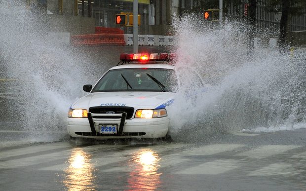 A New York City Police car drives through a flooded intersection on 43nd Street in New York on August 28, 2011 as Hurricane Irene hits the city and Tri State area with rain and high winds. A New York City Police car drives through a flooded intersection on 43nd Street in New York on August 28, 2011 as Hurricane Irene hits the city and Tri State area with rain and high winds.