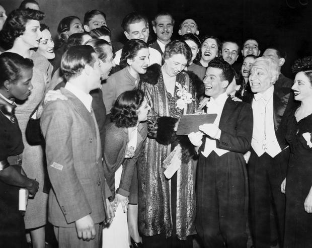 Performers look on as Al Levy, a 'Pins & Needles' performer, gets the autograph of Eleanor Roosevelt following the performance at the Labor Stage, November 1945.