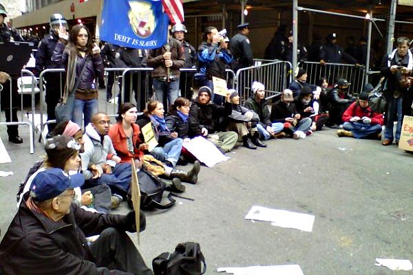 Demonstrators sit in protest in the Financial District.
