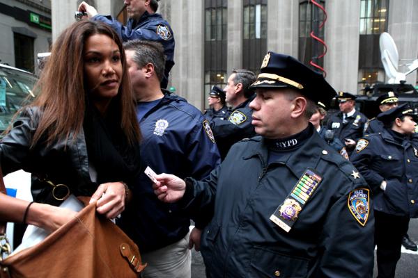 Police inspecting IDs of all people entering Wall Street.