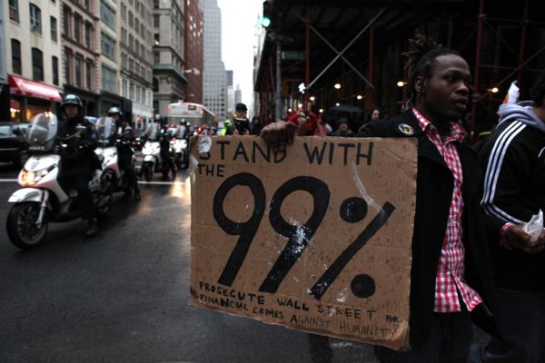 Protesters, many carrying signs, march toward Union Square.