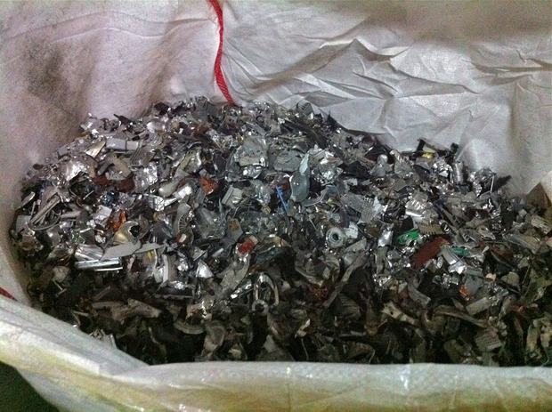 Shredded pieces of metal from e-waste are grouped together and bagged. We Recycle! will sell the pieces to another recycler, who will melt the metal down to make new products and devices.