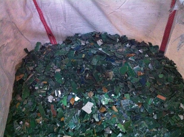 Shredded pieces of circuit boards from e-waste are grouped together and bagged. We Recycle! will sell the pieces to another recycler, who will recover precious metals from the boards.