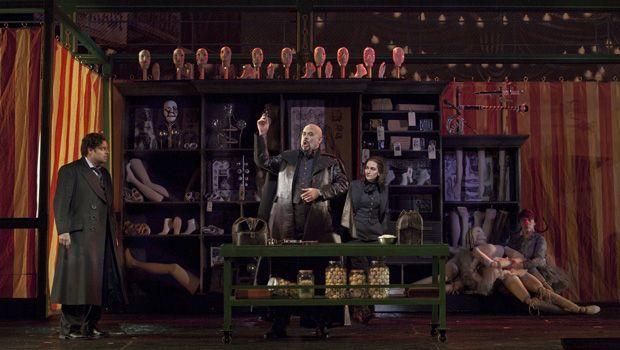 A scene from Act I (Olympia act) of Offenbach’s “Les Contes d’Hoffmann” with Joseph Calleja as Hoffmann, Alan Held as Coppelius, and Kate Lindsey as Nicklausse. A scene from Act I (Olympia act) of Offenbach’s “Les Contes d’Hoffmann” with Joseph Calleja as Hoffmann, Alan Held as Coppelius, and Kate Lindsey as Nicklausse.