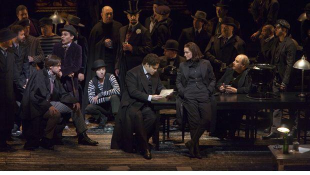 A scene from the Prologue of Offenbach's 'Les Contes d'Hoffmann' with Michael Todd Simpson as Hermann (seated on left), Joseph Calleja as Hoffmann, and Kate Lindsey as Nicklausse. A scene from the Prologue of Offenbach's