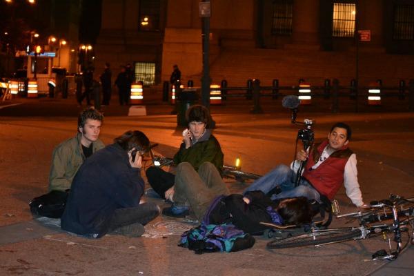 A common scene in lower manhattan Tuesday morning were small groups of evicted protesters and supporters sitting, waiting, and seeking more information from friends via cell phone.