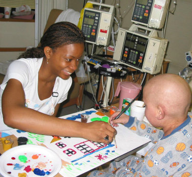 An art therapy student paints with a patient as part of Shands Hospital’s Arts in Healthcare program in Gainesville, Florida. Bringing the arts into hospital settings helps to humanize healthcare and