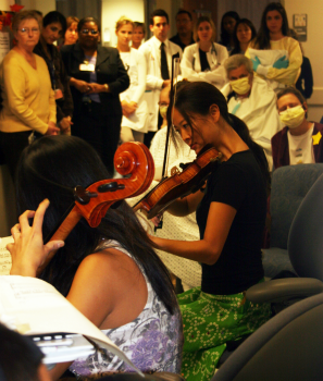 The Ahn Trio performs for patients and staff at Shands Hospital. Arts programs at hospitals cost little, but are often perceived by patients and visitors as a welcome luxury.