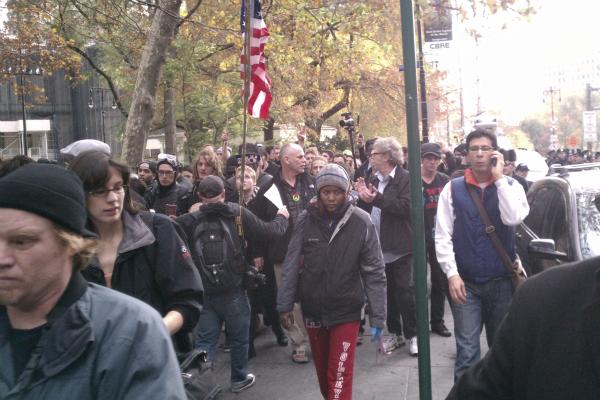 Protesters march through Lower Manhattan after they were cleared from Zuccotti Park early Tuesday.