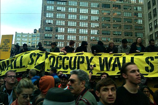 Protesters on top of a wall at Canal Street and Sixth Avenue.