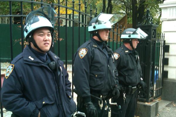 Police in riot gear guard City Hall