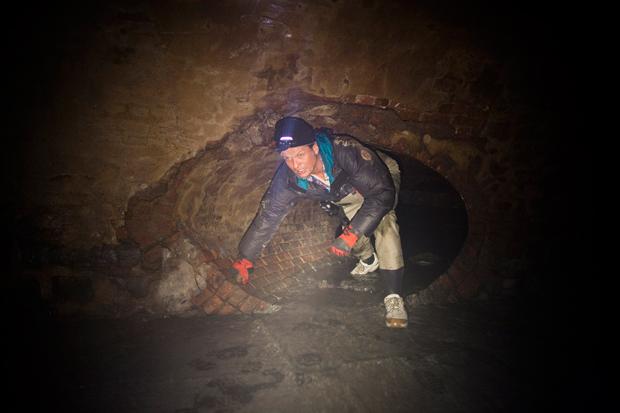 Erling Kagge in side street sewer leading to Canal Street sewer.