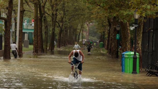 A young man rides his bicycle through flood waters along the East River Bikeway after Hurricane Irene dumped more than six inches of rain August 28, 2011 in New York City. A young man rides his bicycle through flood waters along the East River Bikeway after Hurricane Irene dumped more than six inches of rain August 28, 2011 in New York City.
