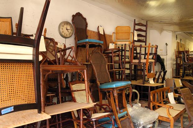 A jumble of chairs at Veteran's Chair Caning and Repair.