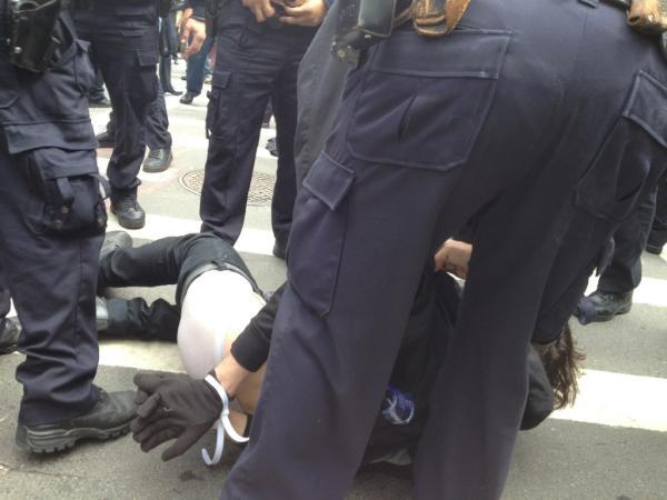 Several protesters dressed in black rushed into the street and were detained.