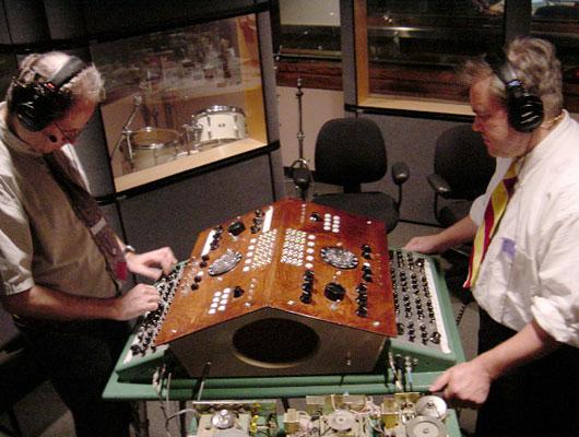 Leon Dewan (left) and Brian Dewan, primates, operate the Dual Primate console.