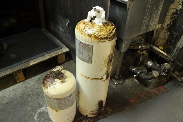 Grease coated extinguishers waiting for cleaning and recharging at Master FIre Prevention.