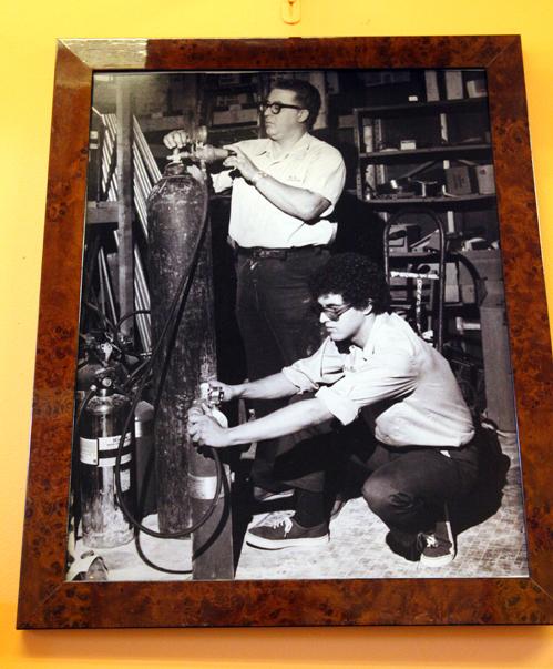 A photograph hanging on the wall of Peter Martinez Sr. and Jr. at Master Fire Prevention.