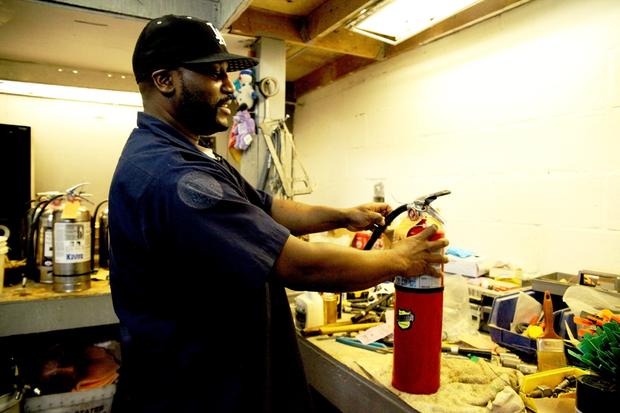Henry Bryant recharging an extinguisher.