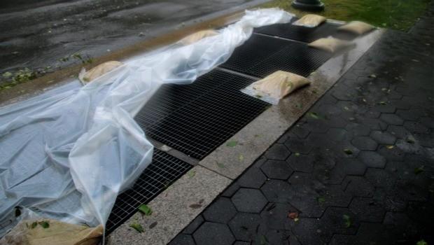 Irene's winds had blown off plastic held down by sandbags meant to keep water out of subway grates in Crown Heights, Brooklyn. Irene's winds had blown off plastic held down by sandbags meant to keep water out of subway grates in Crown Heights, Brooklyn.