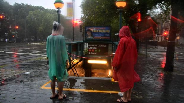 Poncho'd figures at the Franklin Park subway stop. Save a few people, most Crown Heights residents were inside on Sunday morning. Poncho'd figures at the Franklin Park subway stop. Save a few people, most Crown Heights residents were inside on Sunday morning.