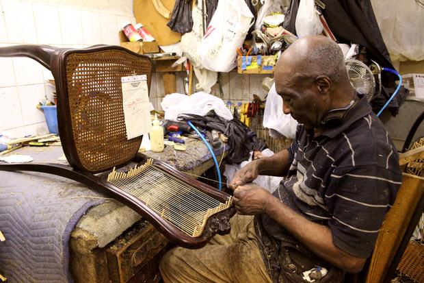 Dorvan Jordan, 77, working on chair with a French caning style.