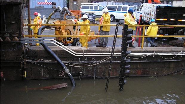 New York City Transit employees pumping water out of the 148th Street / Lenox Subway Yard. New York City Transit employees pumping water out of the 148th Street / Lenox Subway Yard.