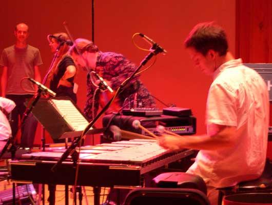 WNYC Engineers Rob Christiansen and Jennifer Munson look over the setup for violinist Todd Reynolds and percussionist David Cossin, 9/28/04.
