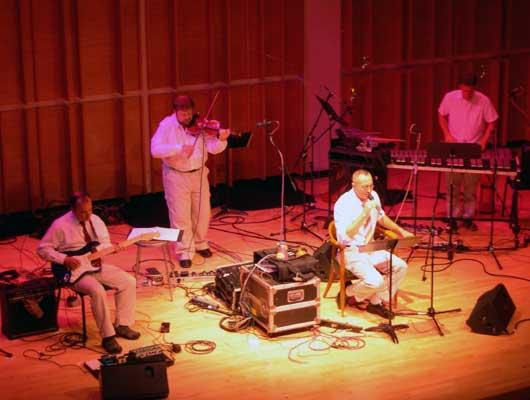 The Zippo Band. Phil Kline, guitar; Todd Reynolds, violin; Theo Bleckmann, vocals; and David Cossin, percussion. Merkin Hall, 9/28/04.