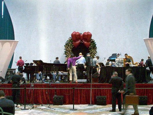 Margaret Leng Tan (center, in purple) looks over the score with Aaron Jay Kernis as Alarm Will Sound sets up, 12/9/03.